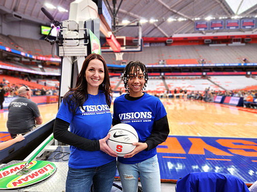 On the court at SU Women's Basketball vs. Boston College is Samantha (In-School Financial Wellness Officer) and Tatanya (High School Student Intern Ambassador).